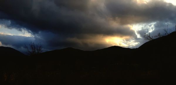 Scenic view of silhouette mountains against sky during sunset
