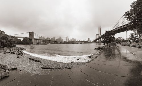 View of bridge over river against cloudy sky