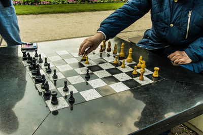 Senior man playing chess in the park