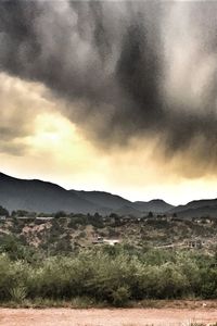 Scenic view of mountains against cloudy sky