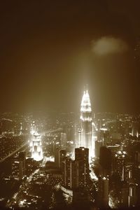 Illuminated cityscape against sky at night