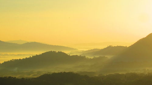 Scenic view of mountains during foggy weather at morning