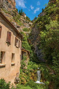 View of houses near creek and bluff at moustiers-sainte-marie, in the french provence.