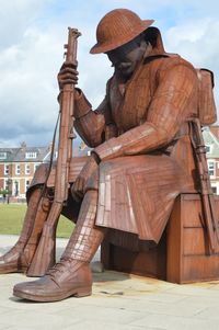 Man on wood against sky