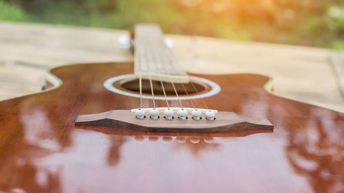 Close-up of guitar on table