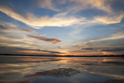 Scenic view of lake against sky at sunset