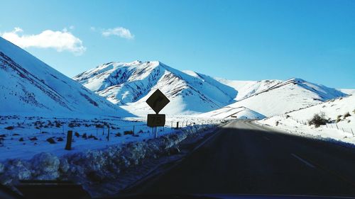 Snow covered mountain against blue sky