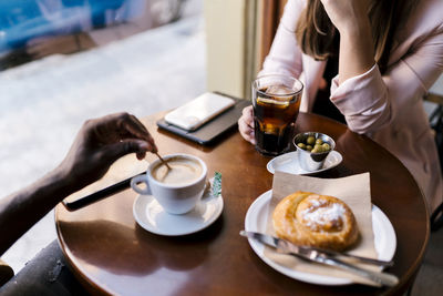 Boyfriend and girlfriend having drinks in cafe