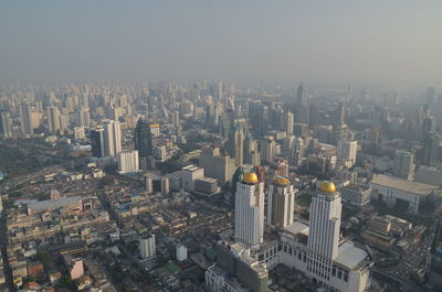 Aerial view of modern buildings in city against sky