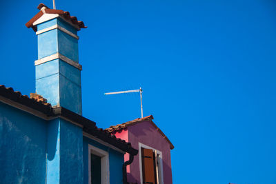 Low angle view of building against clear blue sky