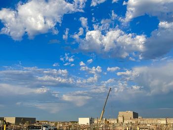 Low angle view of buildings against cloudy sky