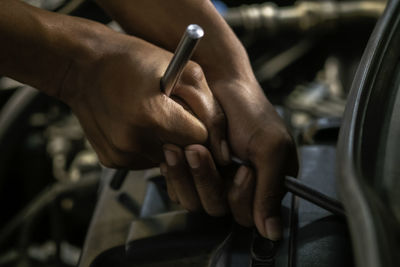 Close-up of hand holding cigarette