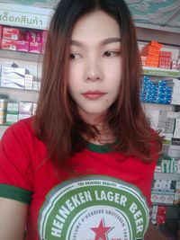 Portrait of beautiful young woman standing in store