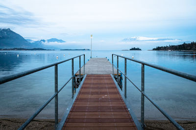 Pier over lake against sky