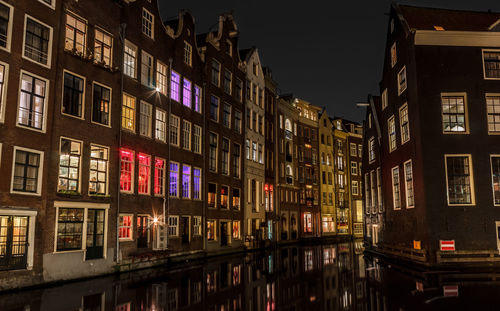 Illuminated city against sky at night