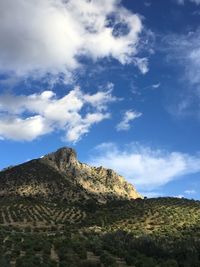 Low angle view of rocky mountain against sky