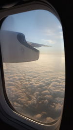 Aerial view of clouds seen through airplane window