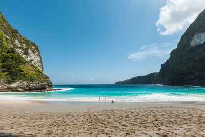 Scenic view of beach against blue sky