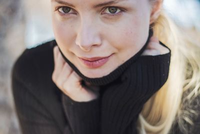 Close-up portrait of smiling young woman