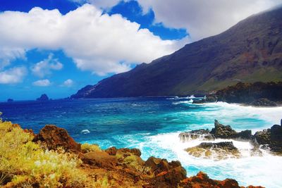 Scenic view of sea against cloudy sky