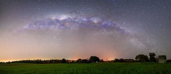 Scenic view of field against star field