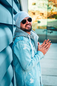 Young man wearing sunglasses standing outdoors