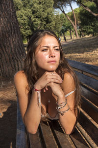 Portrait of young woman sitting outdoors