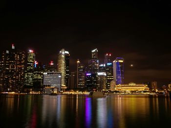 Illuminated cityscape against sky at night