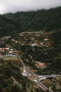 High angle view of highway by mountain against sky