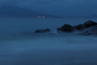 Scenic view of sea against sky at dusk