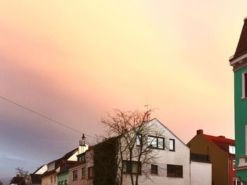 High section of building against sky at sunset