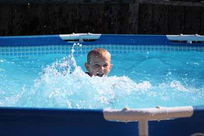 Boy swimming in pool