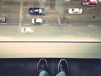 Low section of person standing on road