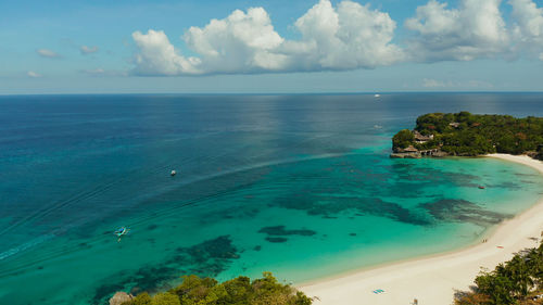 Sandy beach with blue water at tropical resort top view, boracay, philippines. 