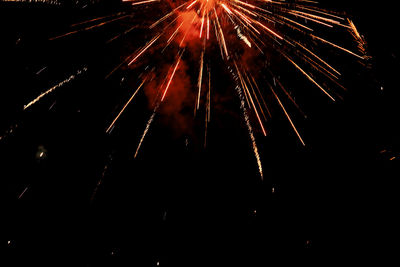 Low angle view of firework display at night