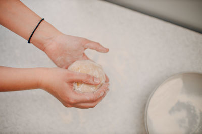 Cropped hand of person preparing food