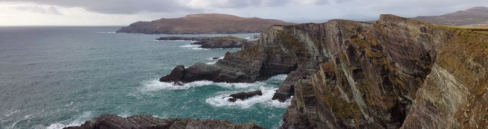 Panoramic view of sea and mountains against sky
