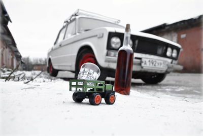 Close-up of toy car on snow covered land