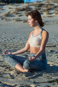 Young woman sitting on beach