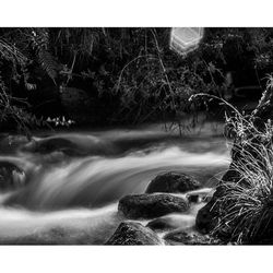 Scenic view of river flowing through rocks