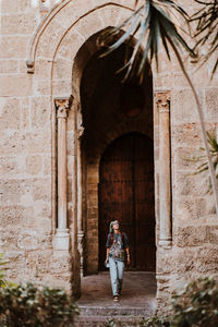 Rear view of man walking in tunnel
