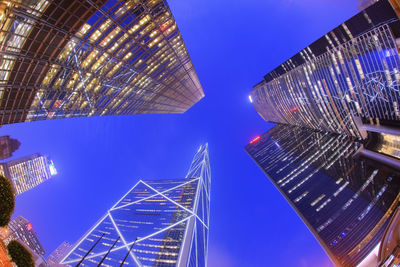 Low angle view of modern buildings against blue sky