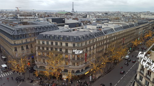 High angle view of crowd on street amidst buildings in city