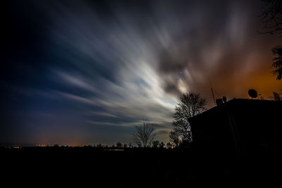 Low angle view of silhouette trees against sky at sunset