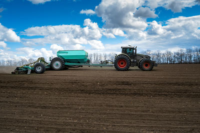 Tractor on field against sky