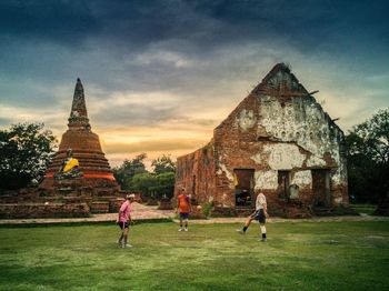 People at temple against sky