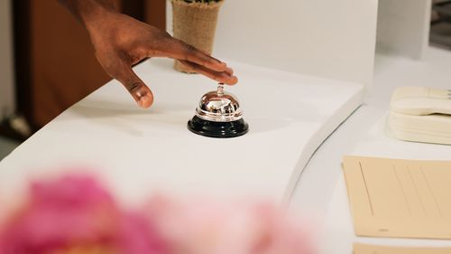 Cropped hand of man holding food on table