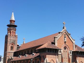 Low angle view of building against clear blue sky