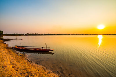 Scenic view of lake against sky during sunset