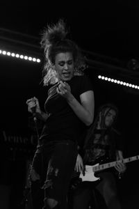 Full length of young woman at music concert